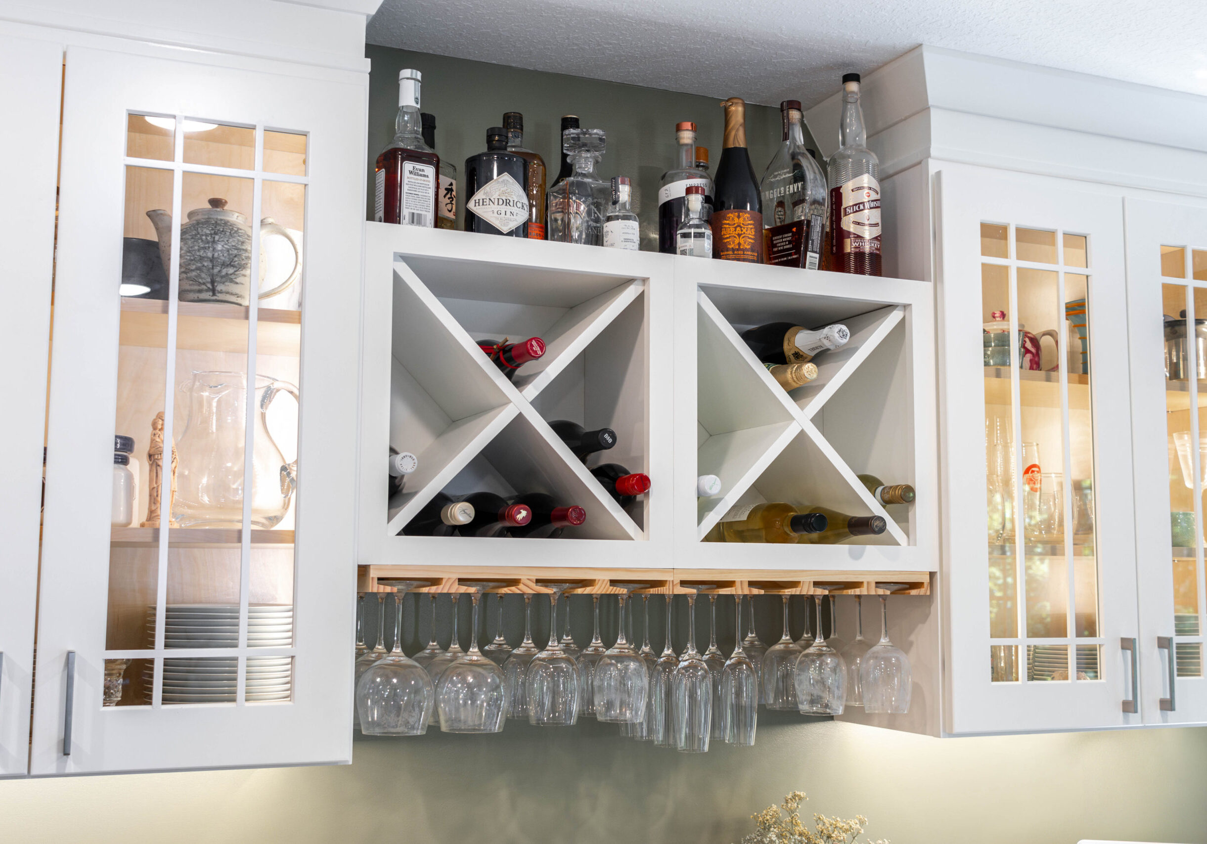 Custom cabinets with built-in wine rack and stained accent
