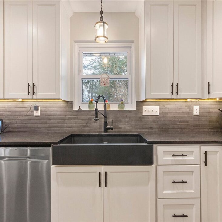 Modern kitchen finishes — white cabinets and stone counters